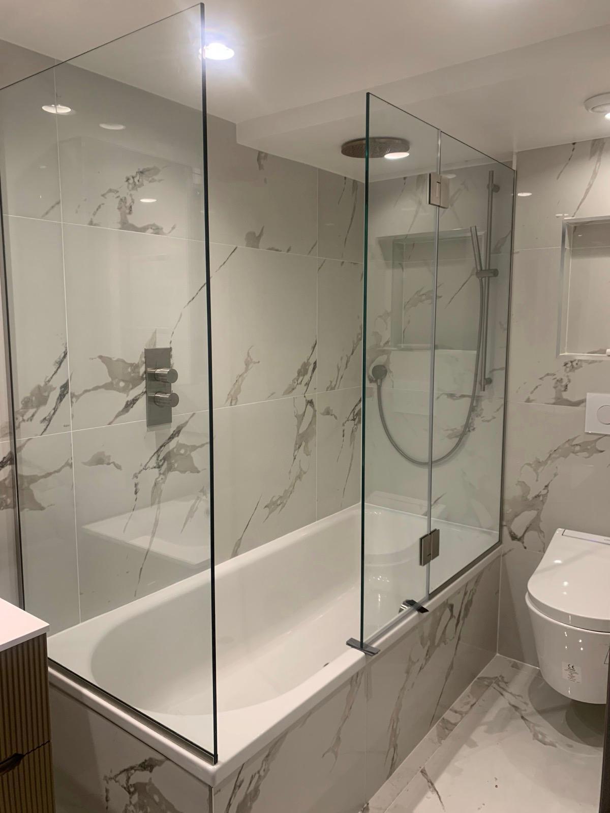 Frameless glass shower screen fitted in West London by Zeenee Aluminium